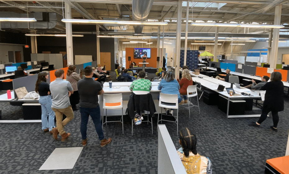 An audience of ScriptDrop team members, both in-person and online, listen with rapt attention as Jeremy Anderson begins his elevator pitch.
